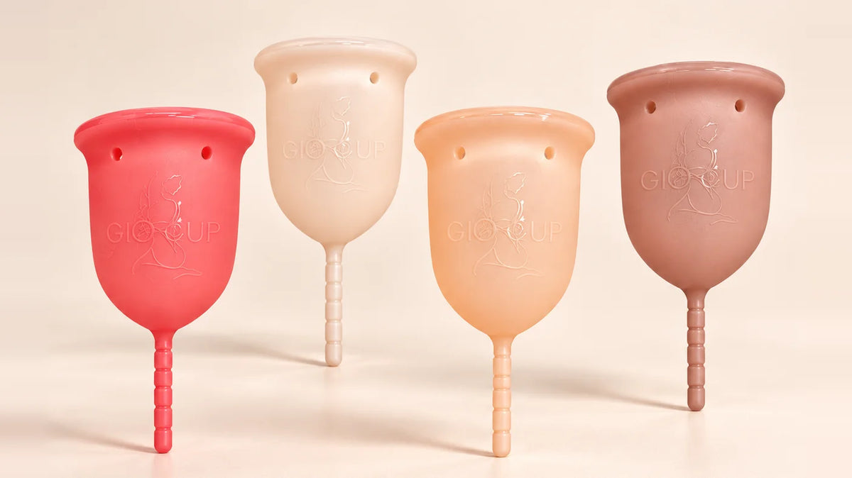The four GIOCUP® menstrual cups standing: Rose, Pearl, Amber and Agate